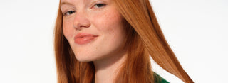Close-up of a person with red hair on a white background